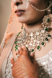 Stunning close-up of Indian bridal jewelry featuring intricate designs with emerald stones.